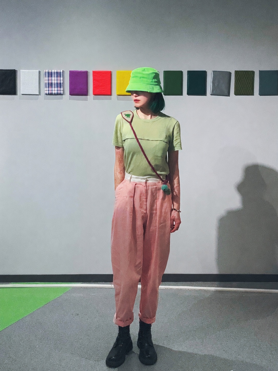 An animal motif Wurdoo worn across the body with a green top and pink trousers