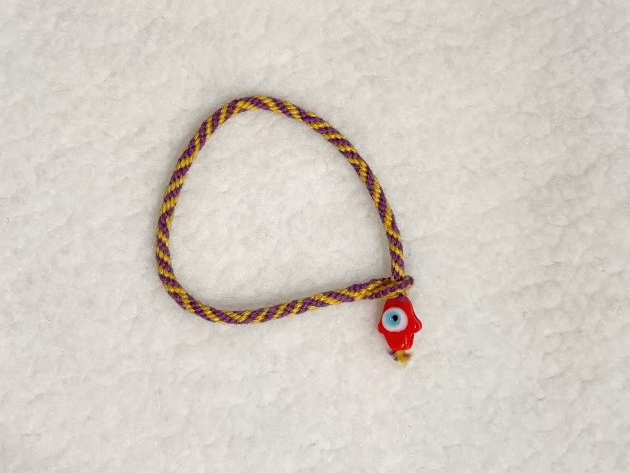 Evil Eye E06 — Plum & gold · Red charm