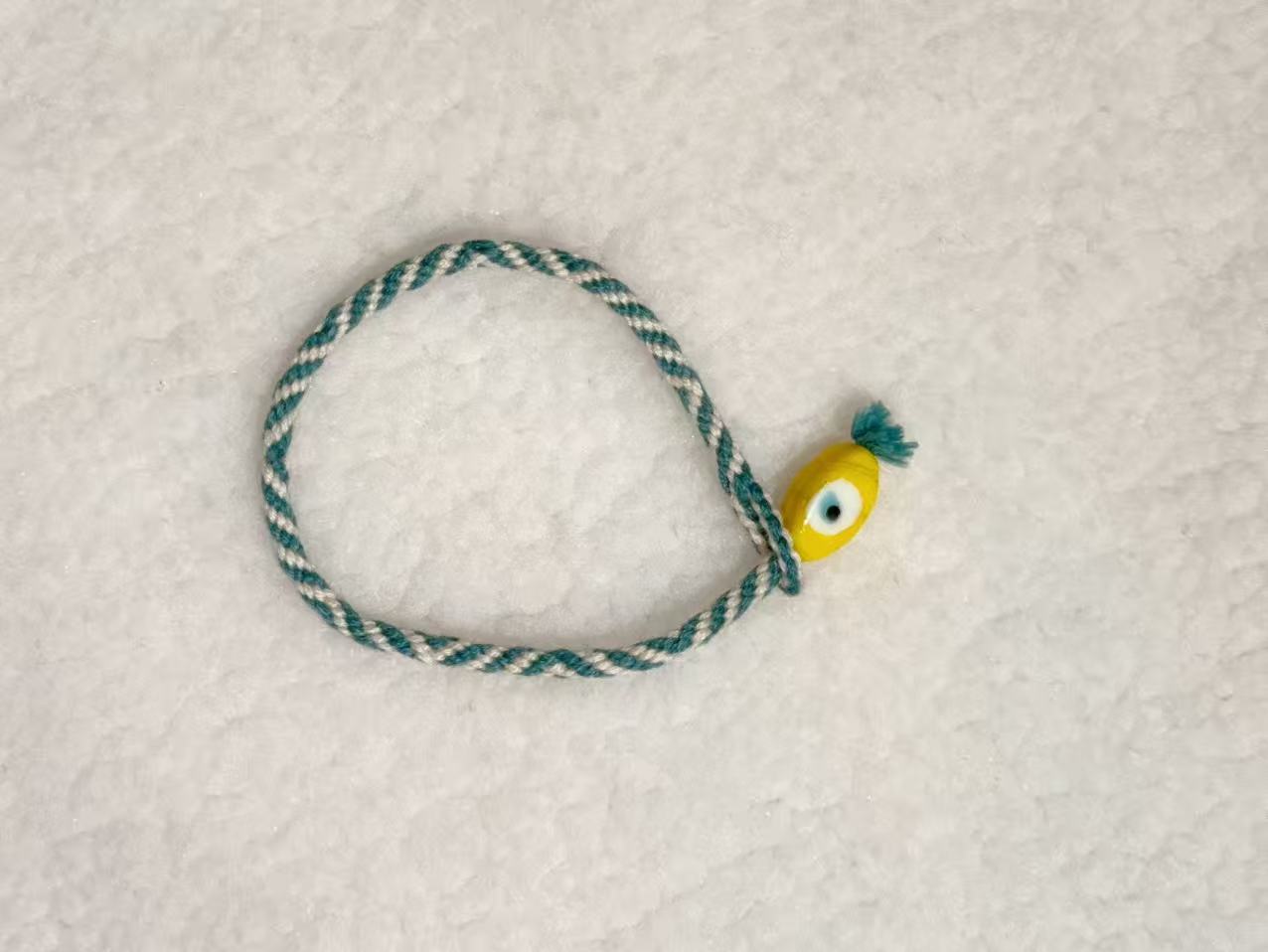 Evil Eye E08 — Teal & cream · Yellow charm