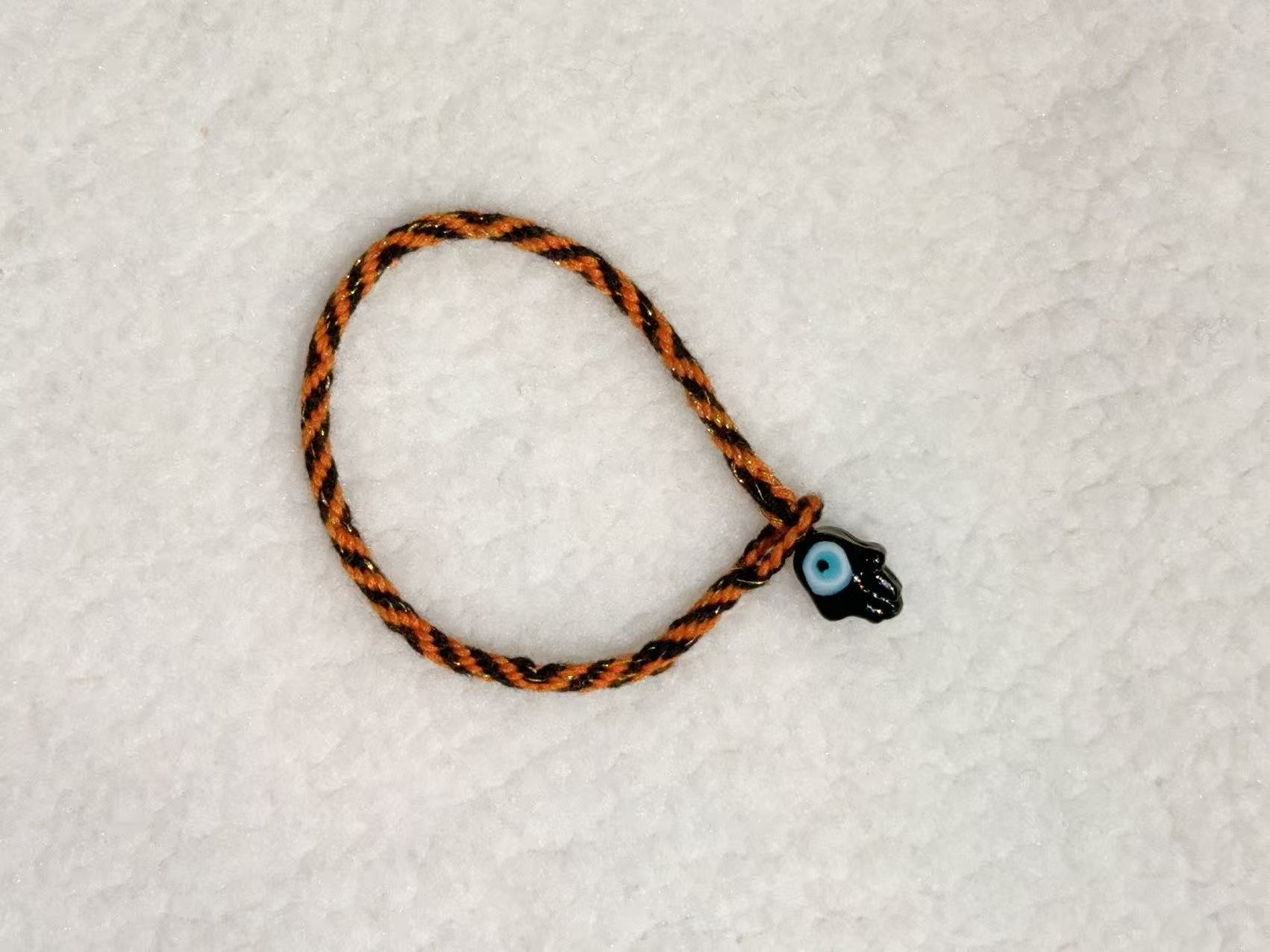 Evil Eye E10 — Orange & black · Dark charm